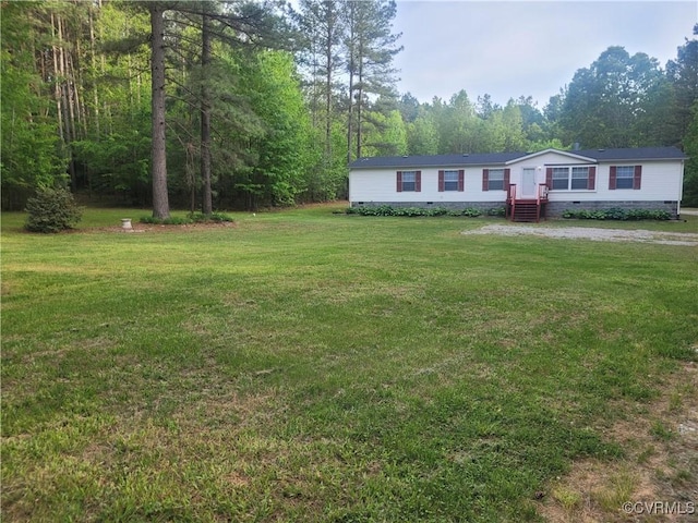 view of yard with a view of trees