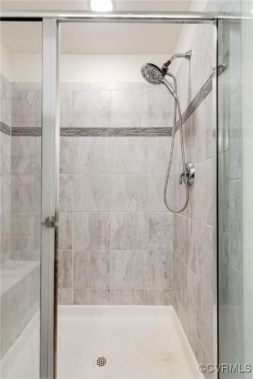 full bath with a shower stall