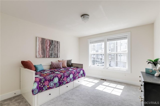 carpeted bedroom with baseboards and visible vents