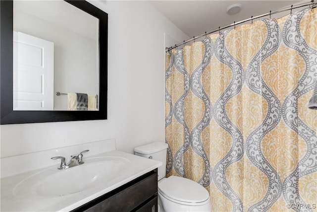 bathroom with vanity, a shower with curtain, and toilet