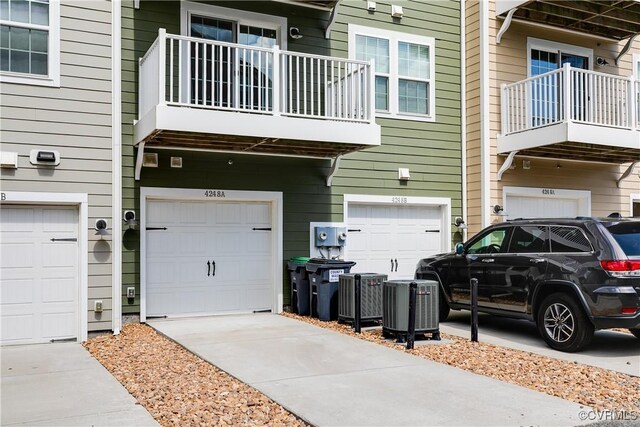garage with central AC and driveway