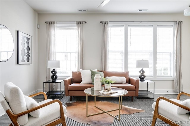 living area with visible vents and baseboards