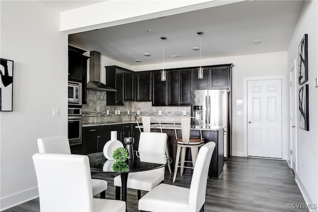 dining room with baseboards and dark wood-type flooring