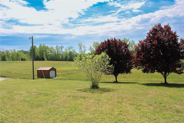 view of yard with a garage, an outbuilding, and a storage unit