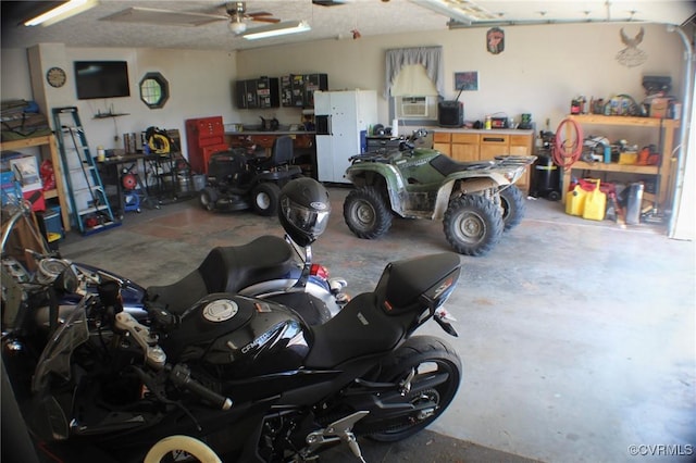 garage with ceiling fan and a workshop area