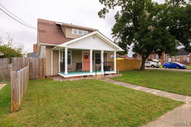 view of front of home featuring fence, a porch, and a front yard