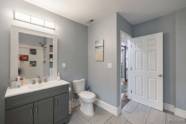 full bath with visible vents, tile patterned flooring, vanity, baseboards, and toilet