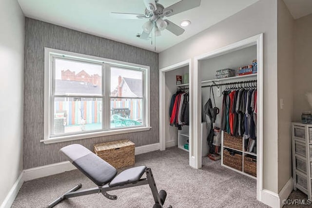 interior space with carpet flooring, a ceiling fan, and baseboards