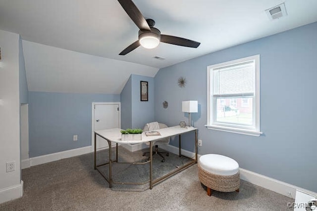 carpeted office space with visible vents, a ceiling fan, baseboards, and vaulted ceiling