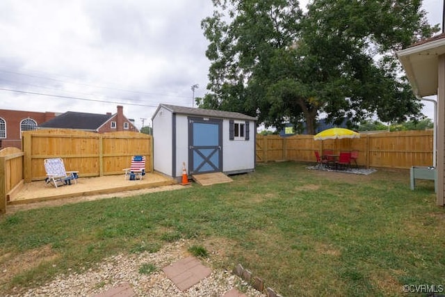 view of yard with a fenced backyard, an outdoor structure, and a shed