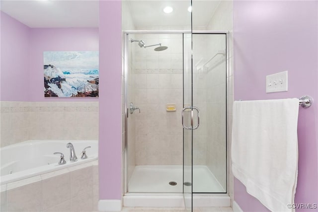 full bath featuring a garden tub and a shower stall