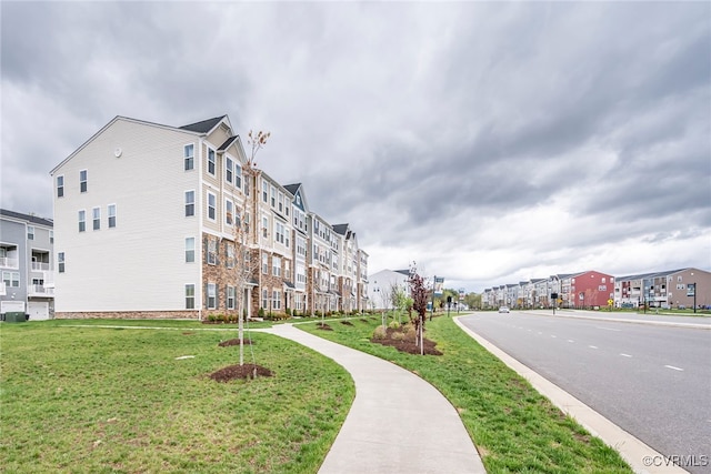 view of home's community featuring a yard and a residential view