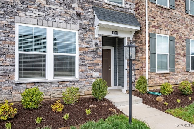 property entrance featuring stone siding