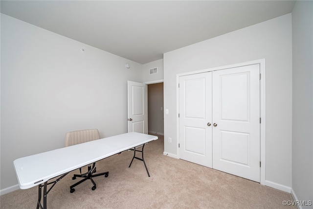carpeted home office featuring visible vents and baseboards