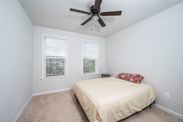 bedroom with carpet floors, a ceiling fan, and baseboards