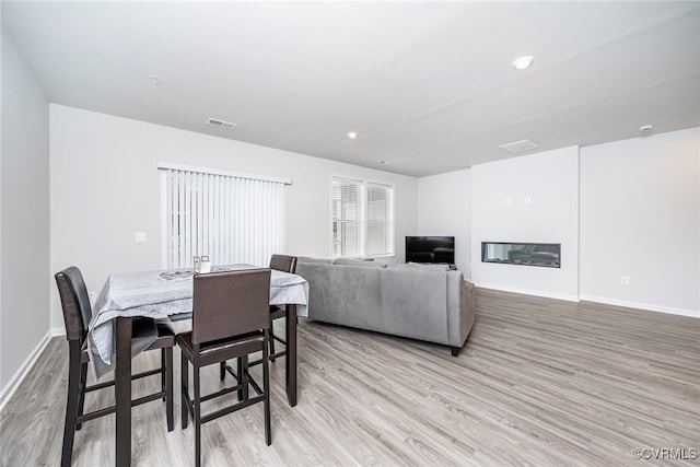 dining area featuring baseboards, recessed lighting, light wood-style flooring, and visible vents
