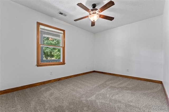 spare room featuring carpet, visible vents, baseboards, and ceiling fan