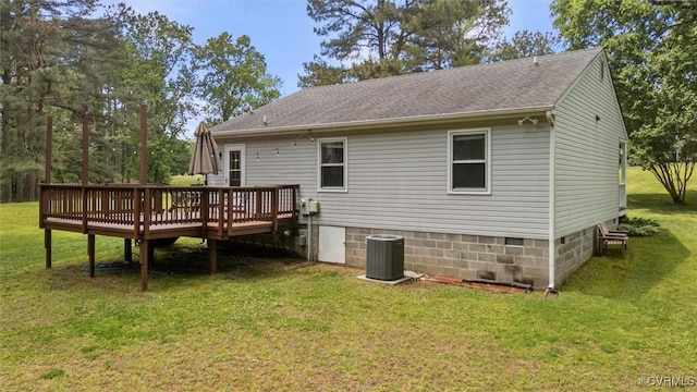 rear view of property featuring a deck, central air condition unit, a yard, a shingled roof, and crawl space