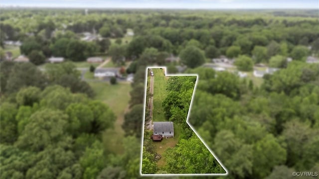 bird's eye view with a wooded view