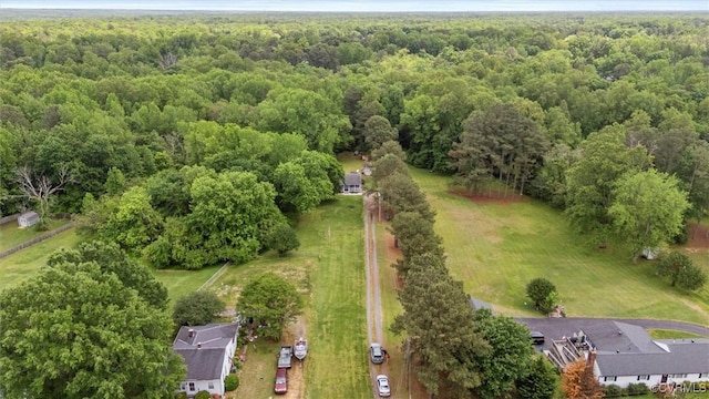 birds eye view of property featuring a wooded view