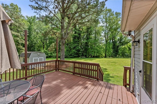 deck with a yard, an outbuilding, and a shed