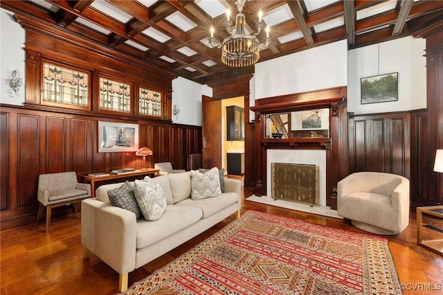 2218 Monument Ave, Richmond, VA 23220 - living room with a fireplace with raised hearth, coffered ceiling, a chandelier, beamed ceiling, and a wainscoted wall