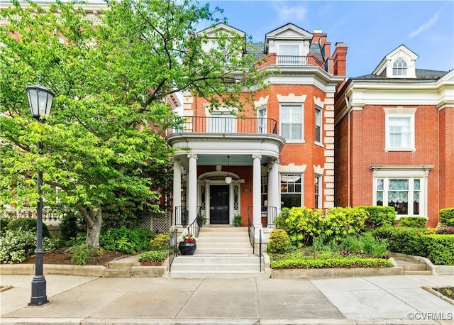2218 Monument Ave, Richmond, VA 23220 - view of front of property featuring a balcony, brick siding, and a chimney
