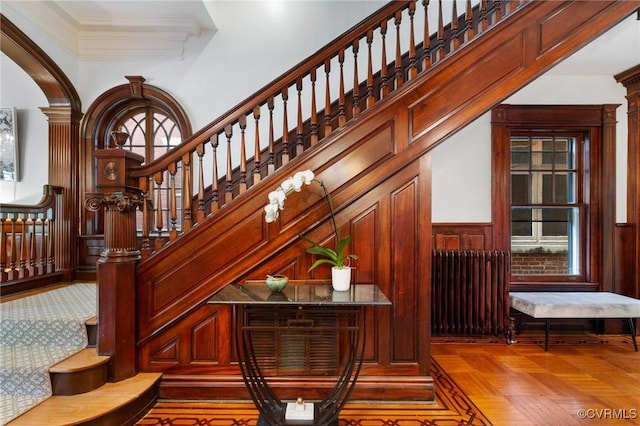 2218 Monument Ave, Richmond, VA 23220 - bar with radiator heating unit, stairs, wainscoting, ornamental molding, and a high ceiling