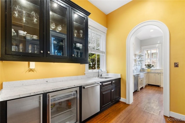2218 Monument Ave, Richmond, VA 23220 - indoor bar with wine cooler, stainless steel dishwasher, wood-type flooring, and arched walkways