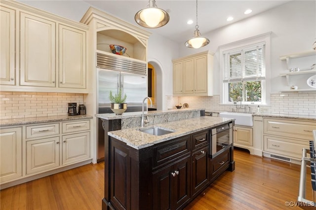 2218 Monument Ave, Richmond, VA 23220 - kitchen featuring open shelves, a sink, cream cabinets, built in appliances, and recessed lighting