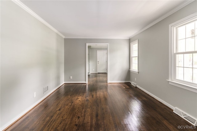 unfurnished room with baseboards, visible vents, dark wood-style floors, and ornamental molding