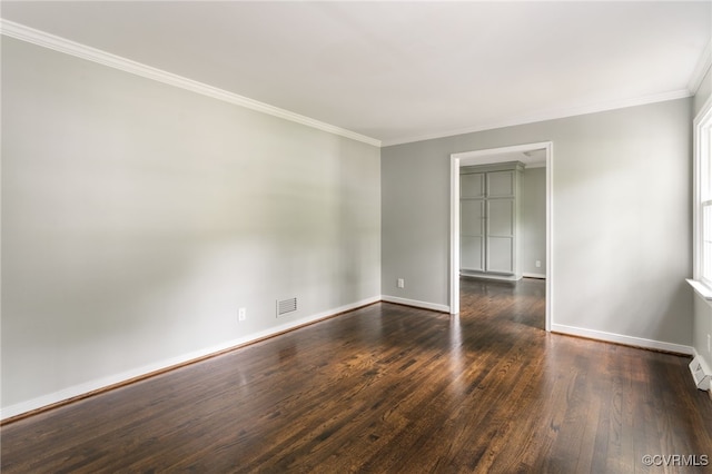 empty room with visible vents, crown molding, baseboards, and dark wood-type flooring
