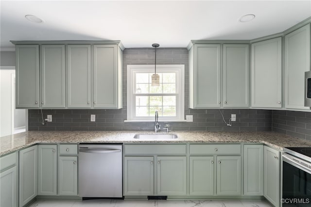 kitchen featuring a sink, appliances with stainless steel finishes, backsplash, and light stone counters