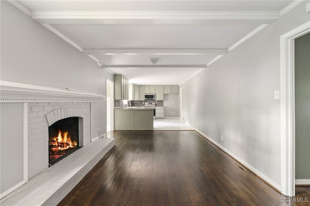 unfurnished living room with baseboards, a fireplace, wood finished floors, and visible vents