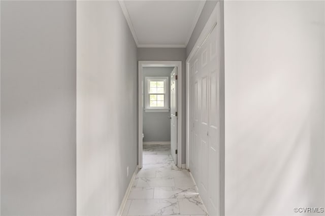 corridor featuring baseboards, ornamental molding, and marble finish floor