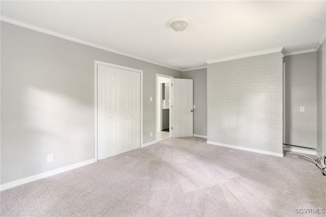 unfurnished bedroom with baseboards, ornamental molding, and carpet