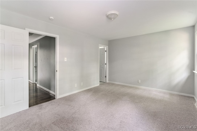 empty room with baseboards and carpet