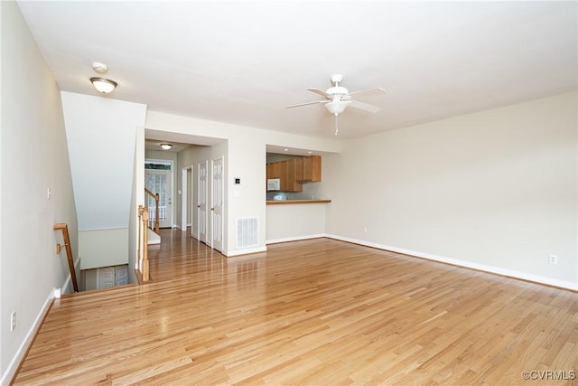 605 Spring St Unit P, Richmond, VA 23220 - unfurnished living room with light wood-style floors, baseboards, and ceiling fan