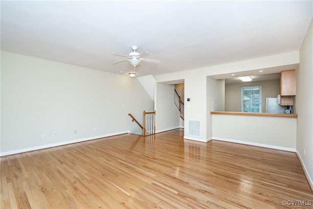 605 Spring St Unit P, Richmond, VA 23220 - unfurnished living room with light wood-type flooring, baseboards, and a ceiling fan