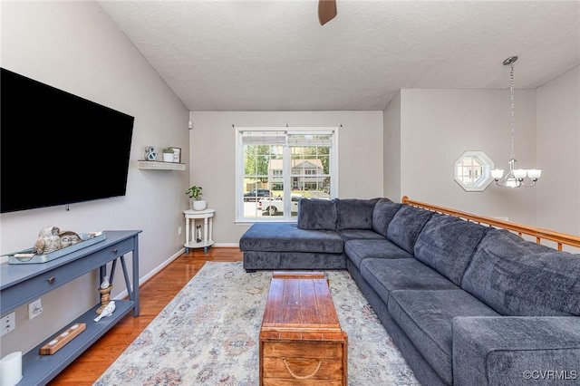 10701 Hamiltons Xing, Fredericksburg, VA 22408 - living area with an inviting chandelier, a textured ceiling, baseboards, and wood finished floors