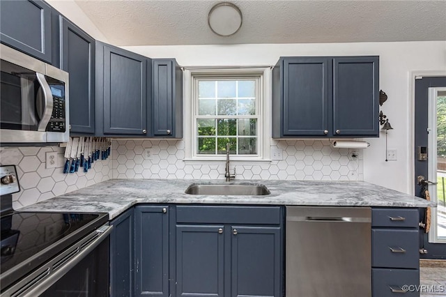 10701 Hamiltons Xing, Fredericksburg, VA 22408 - kitchen featuring backsplash, blue cabinets, a textured ceiling, a sink, and stainless steel appliances