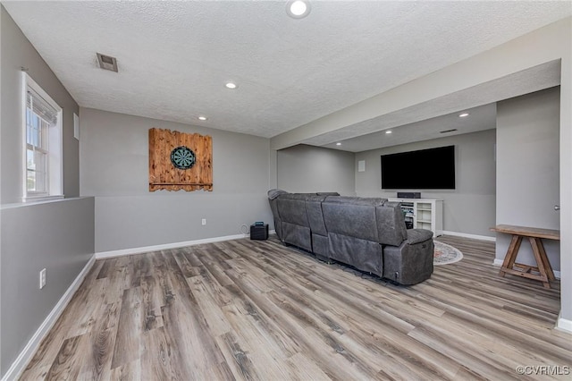 10701 Hamiltons Xing, Fredericksburg, VA 22408 - living room featuring baseboards, a textured ceiling, visible vents, and wood finished floors