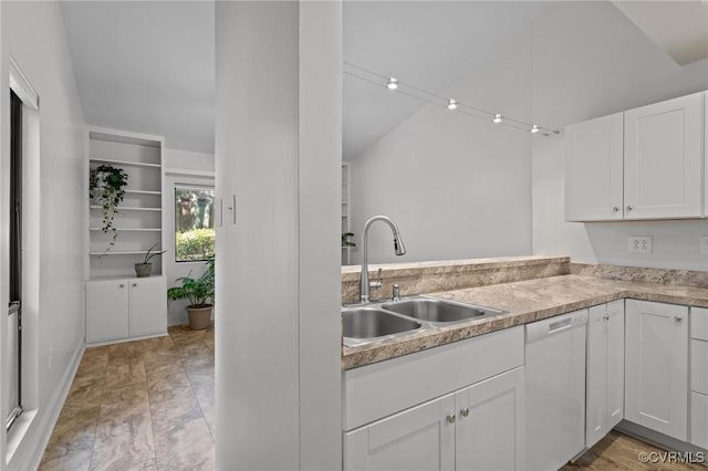 kitchen featuring light countertops, white cabinetry, a sink, dishwasher, and vaulted ceiling