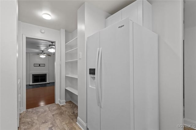 interior space with ceiling fan