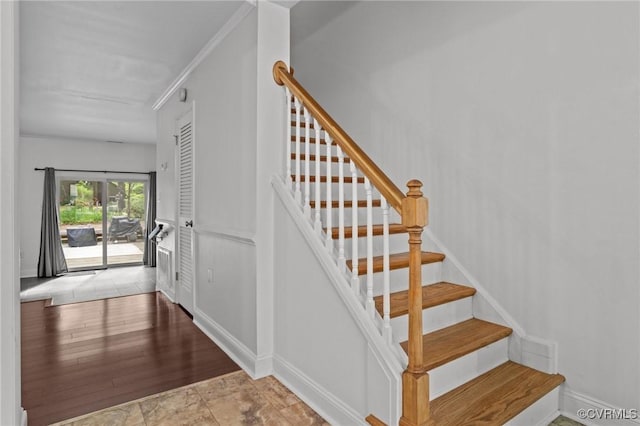 stairway featuring baseboards