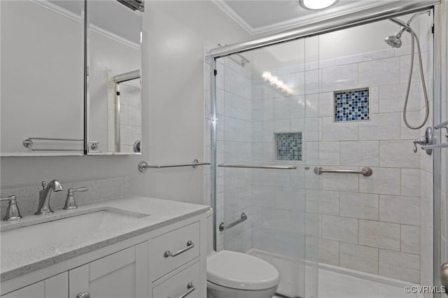 bathroom with crown molding, vanity, a shower stall, and toilet