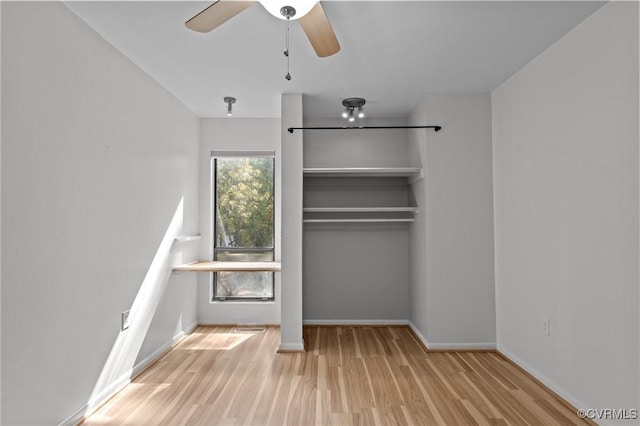 unfurnished bedroom with baseboards, ceiling fan, a closet, and wood finished floors