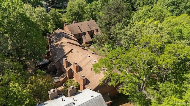 drone / aerial view with a wooded view