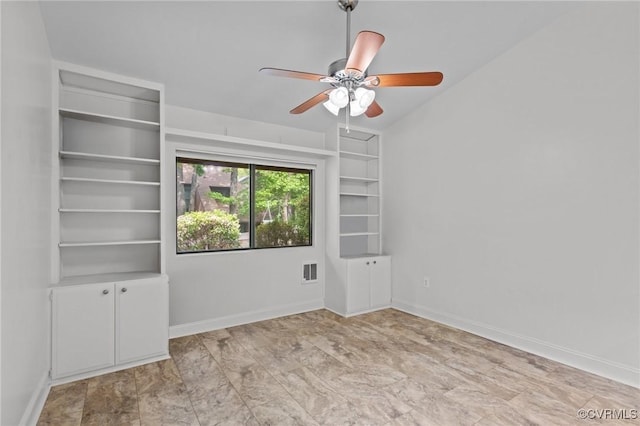 unfurnished room featuring baseboards, a ceiling fan, and visible vents
