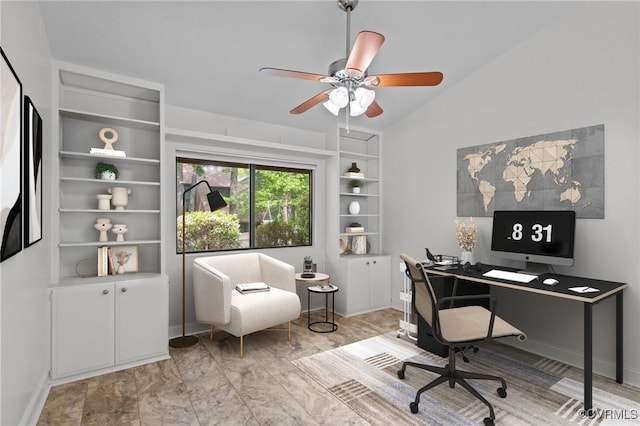 office area featuring ceiling fan, vaulted ceiling, and baseboards